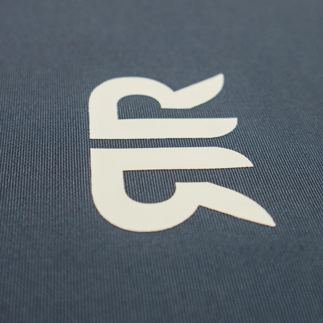 Flex transfer — Single-colour vinyl cut to shape and pressed on.