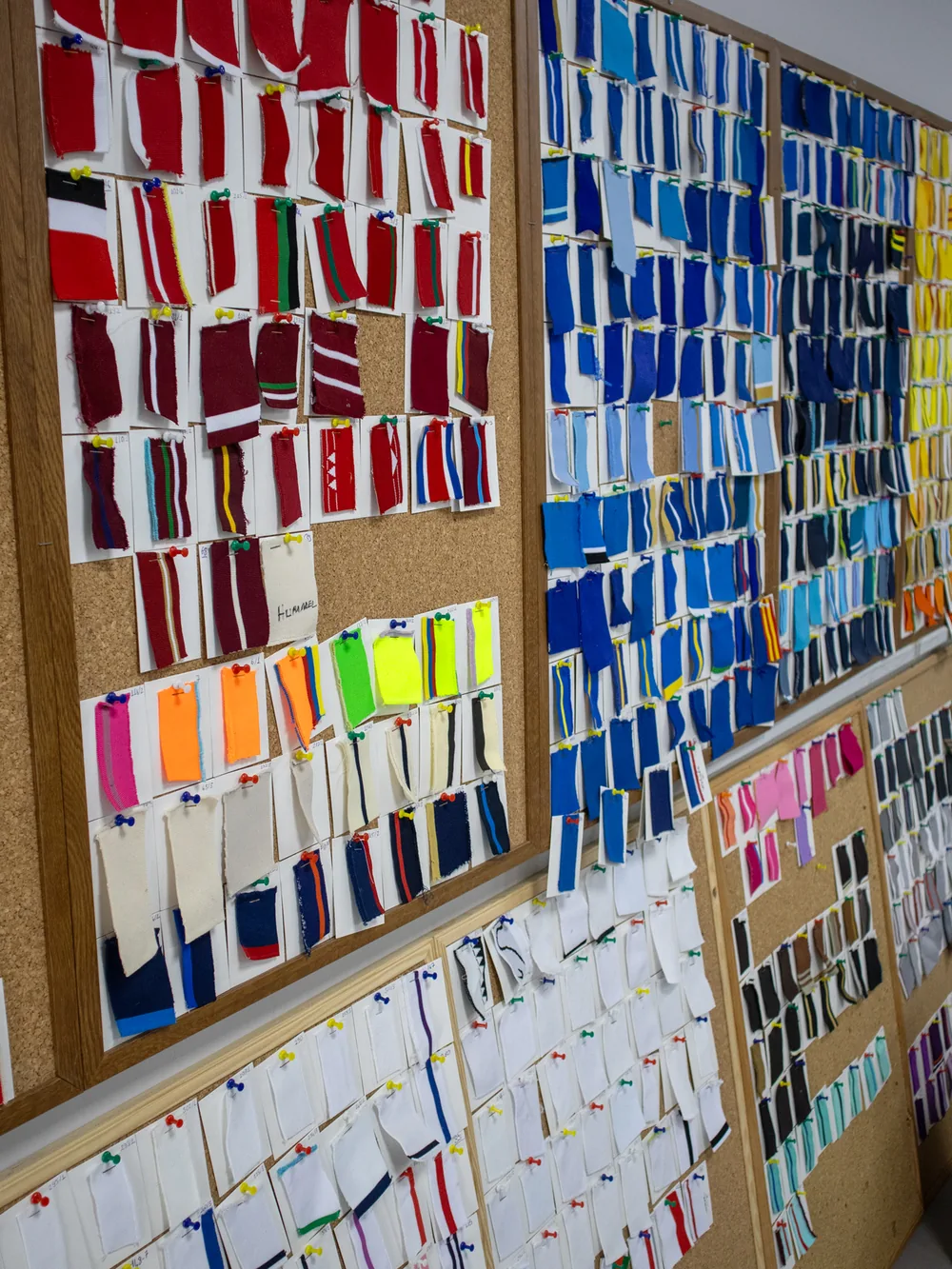 Approved colour swatches pinned to boards by colour family