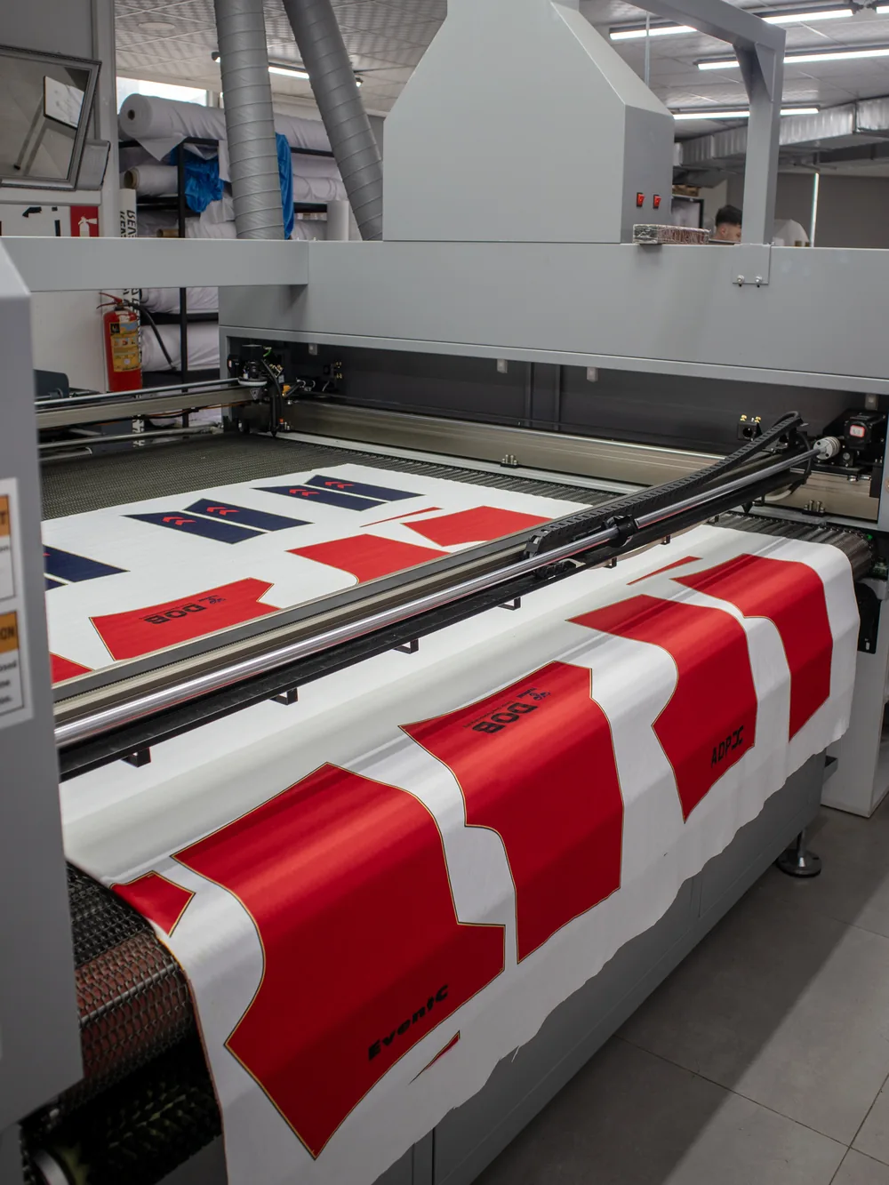 Laser cutter cutting printed panels from the roll