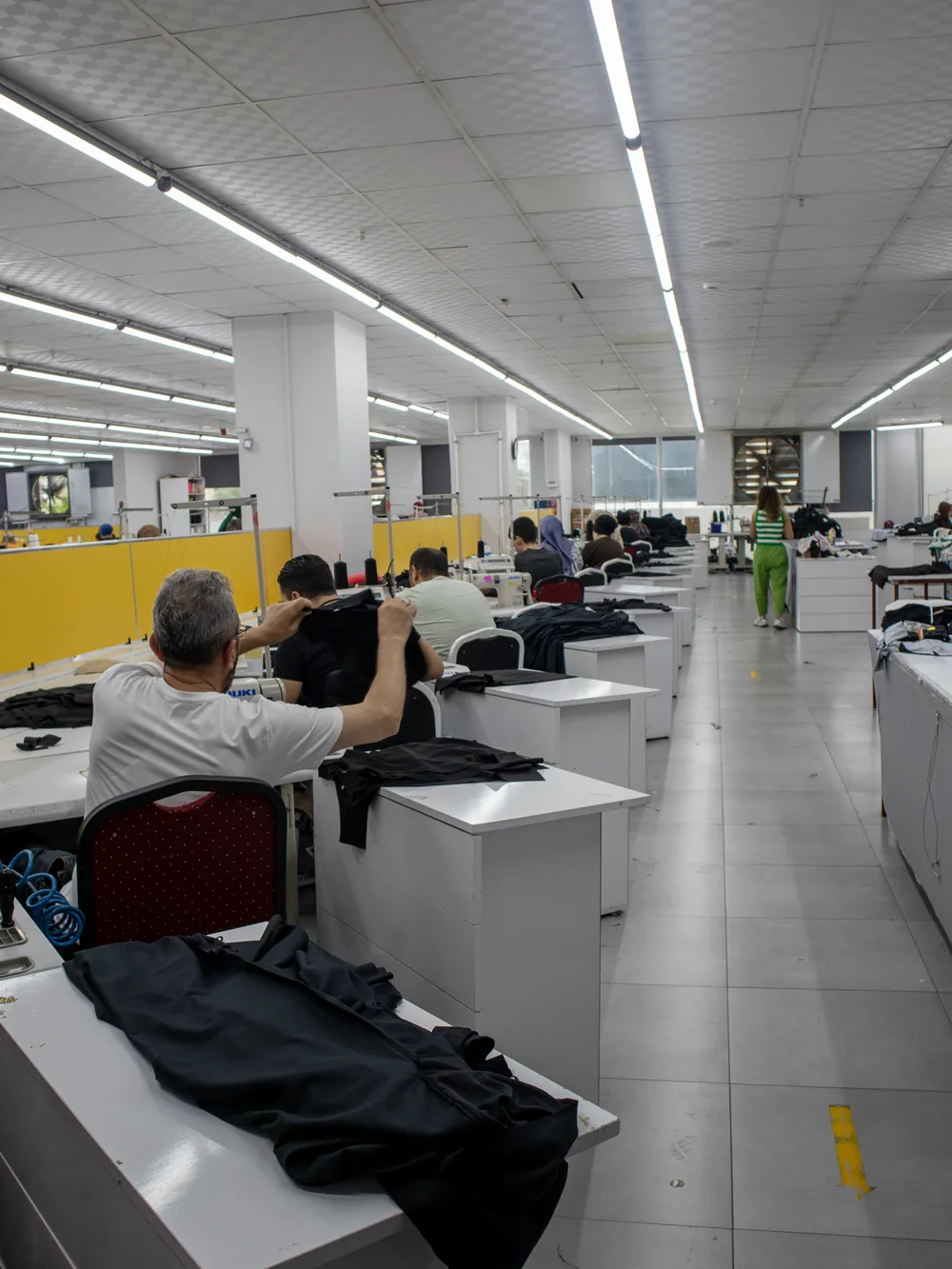 Sewing line assembling garments at the machines