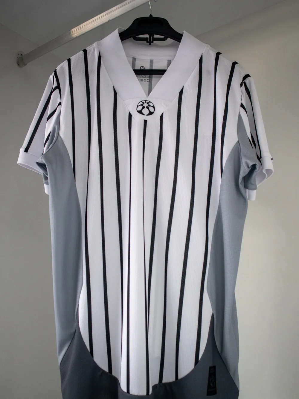A cut & sew panel join: two separately cut fabrics stitched together, not a printed line.