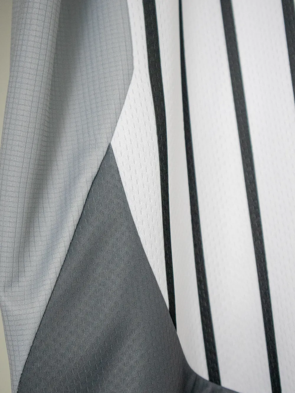 Three constructions in one garment — body, contrast panel and trim, each a different fabric.